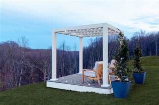 a white canopy with 2 wooden chairs and 2 blue flower pots