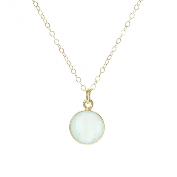 beautiful gold necklace with a round pendent made of mothers milk