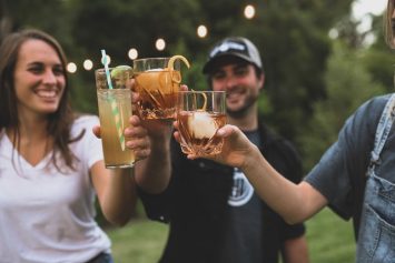 people toasting with drinks made with alcohol