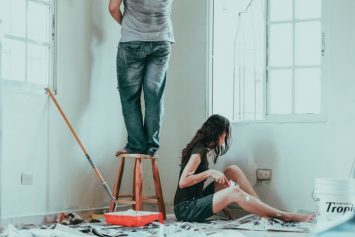 a couple doing home improvements by painting