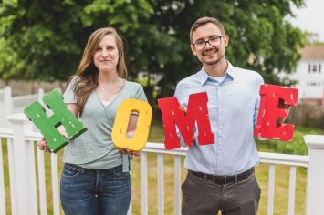 Couple holding letters that form the word home. trying to make your new place feel like home
