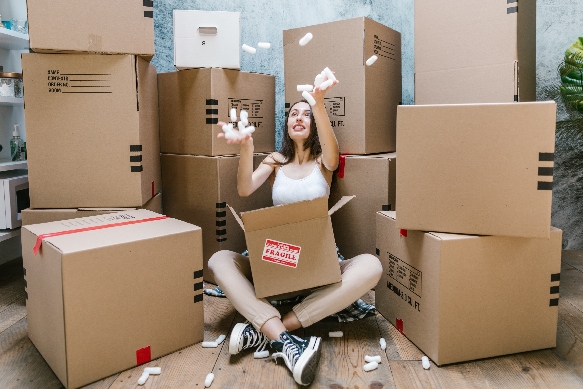 a women surrounded by moving boxes