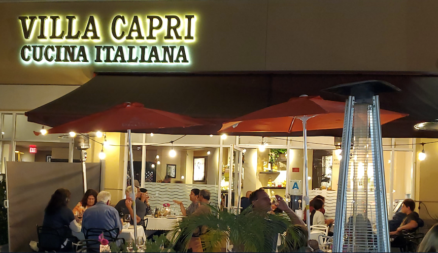 Villa Capri's Front View with a woman standing in front