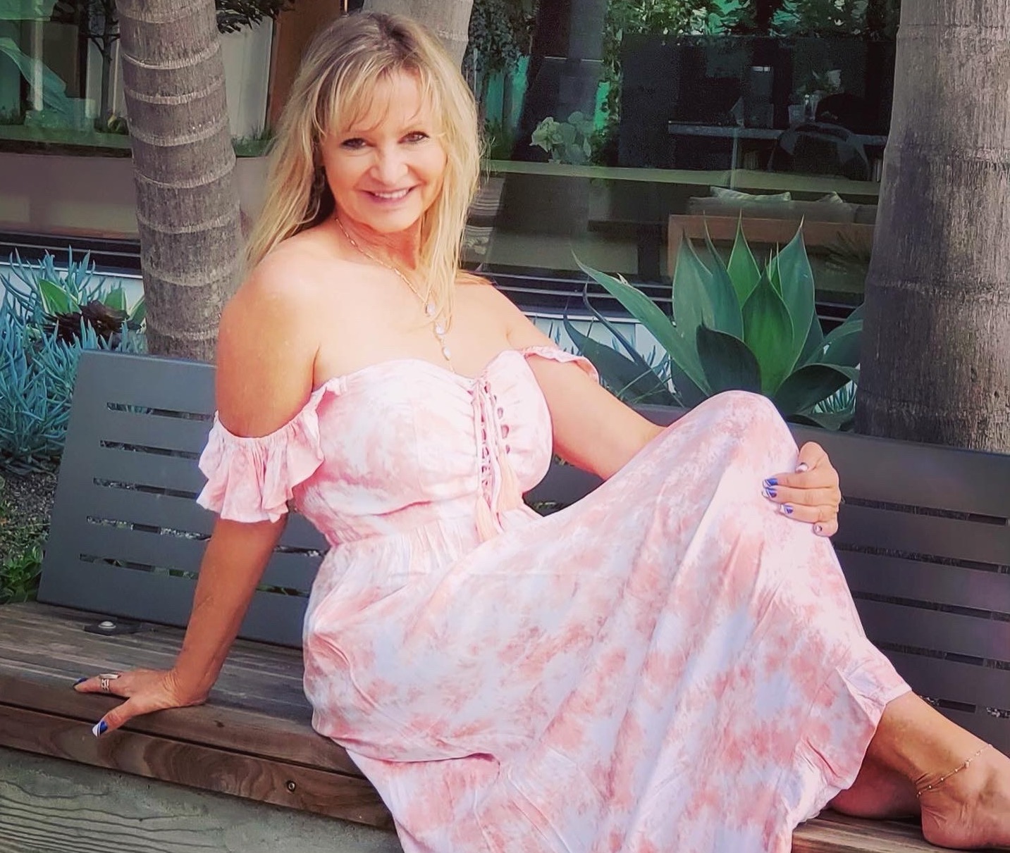 Heather Winfield wearing a pink and white dress from Tiare Hawaii