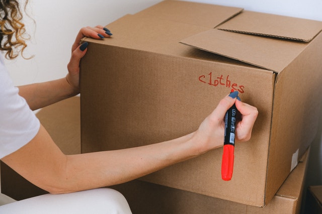 A woman labeling a box