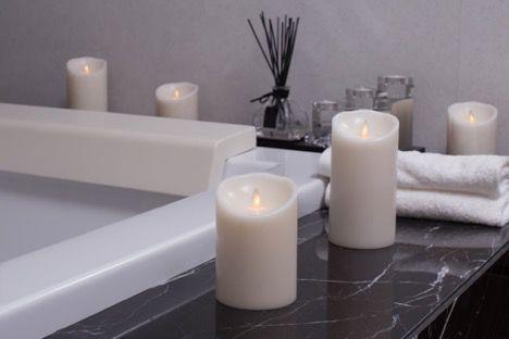 candles lit around the outside of the bath tub to give it a spa feel