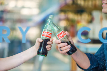 two coke bottles showing Branding And Marketing