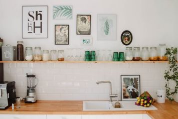 A well-organized shelf with jars and glasses in the kitchen