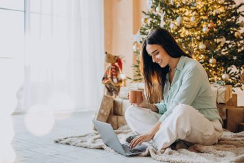 A woman at home shopping for Christmas and holiday gifts