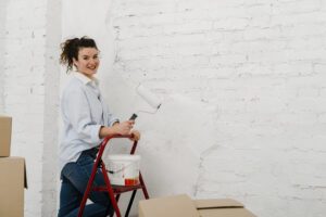 woman-with-paint-roller-looking-camera