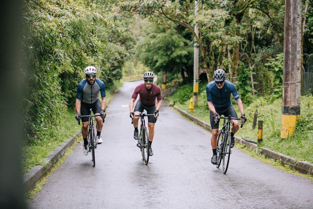 Three men cycling on a trail in nature