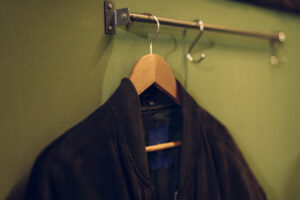 black-jacket-wooden-hanger-hanging-rail-wall