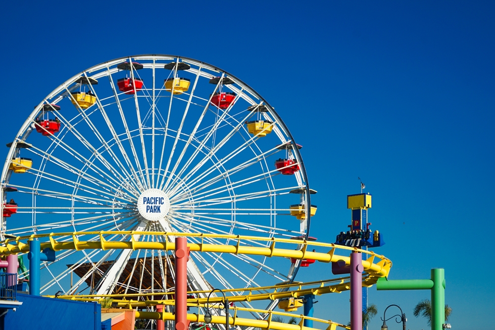 Roller coaster, ferris wheel and a hammer in a colorful amusement