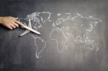 A toy plane on a world map for a stress-free international move