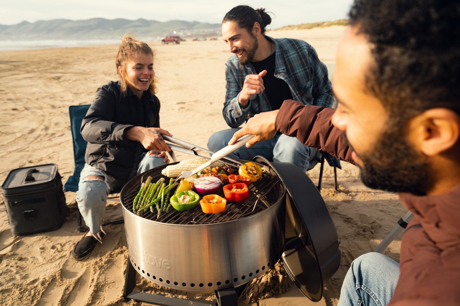 people cooking on a beach