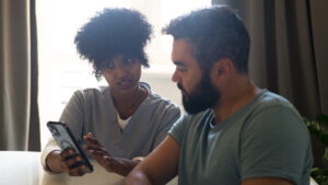 Two people watching at the iphone