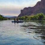 two people kayaking down the river on a first date