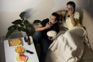 full-shot-couple-watching