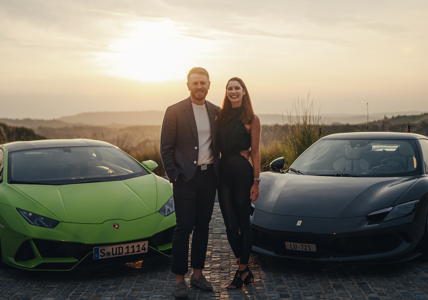 couple with luxury cars