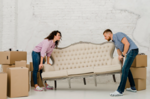 Couple holding sofa