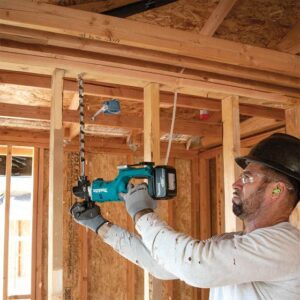 Man drilling on wooden wall with the right drill