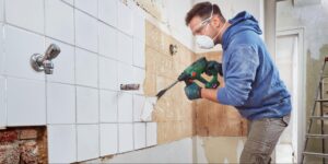 Man drilling on wall
